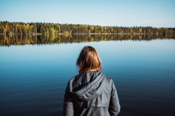 Woman on a peaceful lake during autumn
