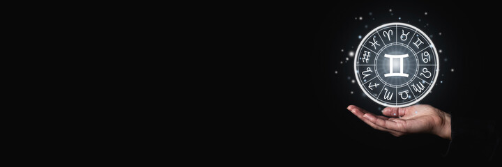 Female palm holds a luminous sign with zodiac signs symbols in the dark. Banner © Alex