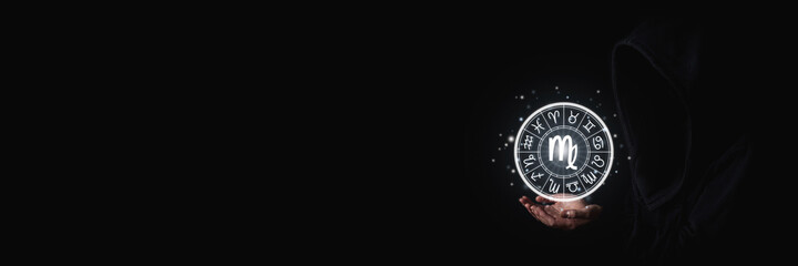 Female hands with palms holding glowing zodiac signs symbols in the dark. Banner
