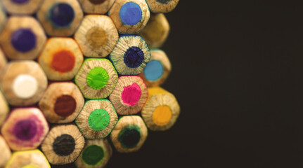 Stack of the color drawing pencils on the black isolated background with copy space, close-up and selective focus photo