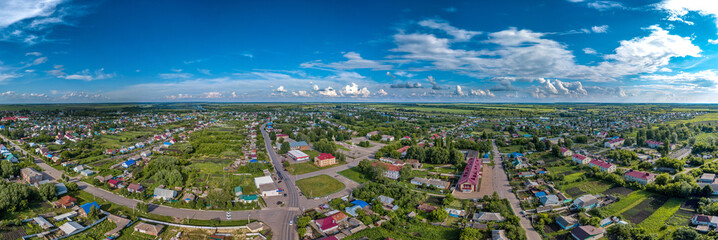 Fototapeta na wymiar small working village Tokarevka (Tambov region, Russia) with houses of classical architecture in the center of Russia - large panorama view from a height on a sunny day