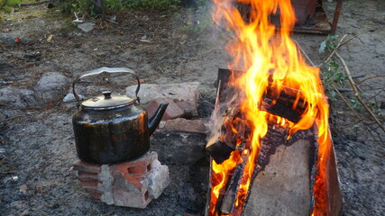 outdoor recreation in the forest by the campfire black kettle bonfire burning wood fire forest camping