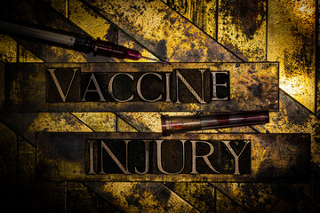 Vaccine Injury text with blood splattered syringe on textured grunge copper and vintage gold background