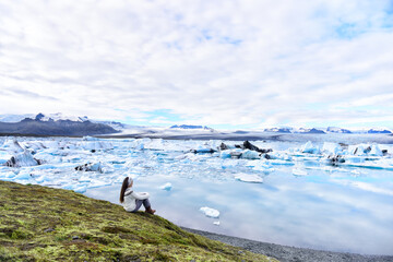 Iceland travel tourist enjoying view of nature landscape Jokulsarlon glacial lagoon glacier lake on...