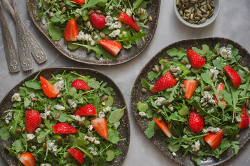 Salad with arugula cheese brie and strawberry