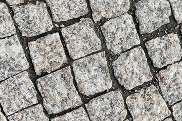 Overhead view of cobblestone street texture. Stone pavement texture