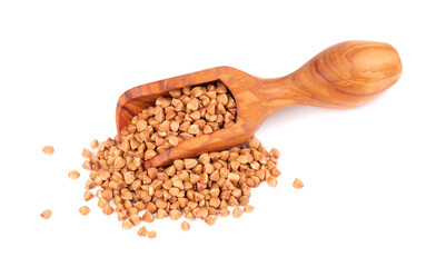 Roasted buckwheat grains in olive scoop, isolated on white background. Dry brown buckwheat groats.