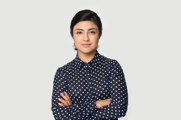 Portrait of young successful Indian woman worker employee stand isolated on grey studio background...
