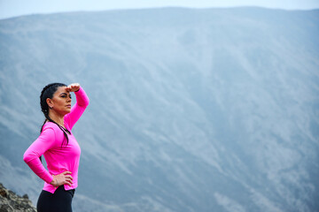 mature woman meditating on the mountain in sportswear