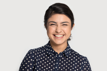 Profile picture of happy young Indian woman isolated on grey background laugh smile show healthy white teeth after dental treatment. Excited biracial ethnic female feel overjoyed. Humor concept.