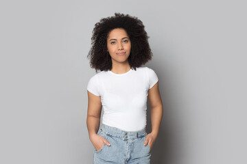 Portrait of millennial African American female in casual clothes isolated on grey studio background posing. Happy young mixed race ethnicity woman modern or actress shooting. Diversity concept. - Powered by Adobe