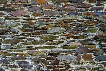 beautiful vintage texture of the wall of a medieval castle built in the middle of the 14th century, multi-colored volumetric stones for the designer, wallpaper, background