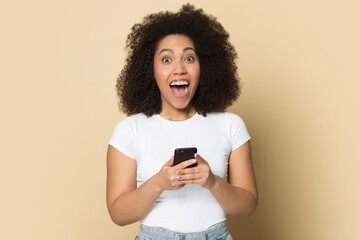 Portrait of excited young African American woman isolated on yellow background triumph celebrate...