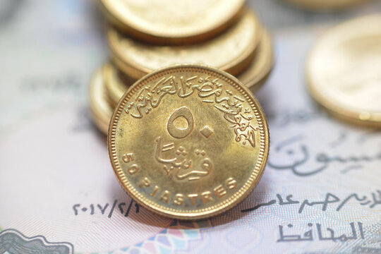 The reverse side of Egyptian 50 fifty piasters 2021 AD, 1442 AH, on a blurred 50 piasters coinage and fifty piasters background, circulating Egyptian coins money background close up view
