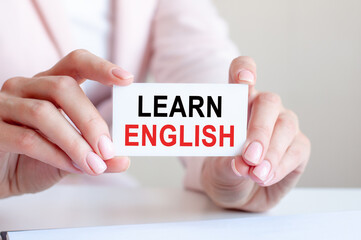 learn english written on a card in woman hands