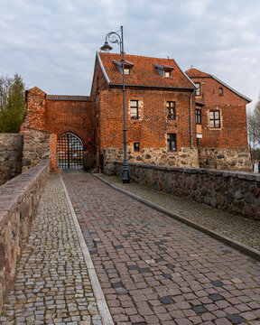 The road and the gate. Medieval Teutonic castle in Sztum, located on Lake Sztumskie in Pomerania (Poland) from 1377.