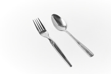 Silvery fork and spoon isolated on white, stainless silverware, tableware and kitchenware