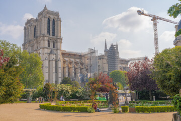 Fototapeta na wymiar Paris, France - 05 02 2021: View of Notre-Dame from Square Rene Viviani Picturesque park near historic church