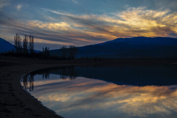 The reflected colors of the sunset in the dam. Kyustendil, Bulgaraia