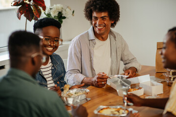 Black friends ordering and eating delivery food at home