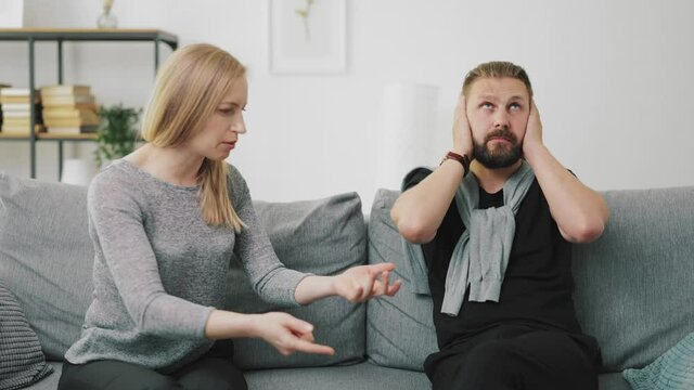 Man ignoring berating wife