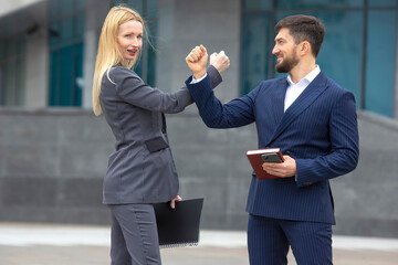 business partners man and woman greet each other with their hands