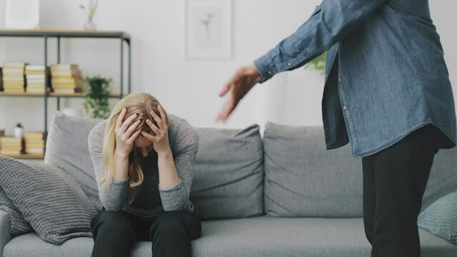 Husband berating wife indoors