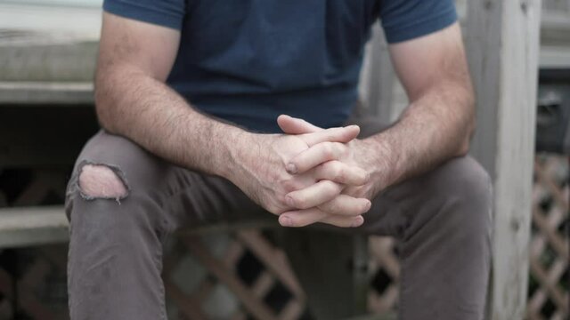 Anxious and stressed middle-age man close up on his hands