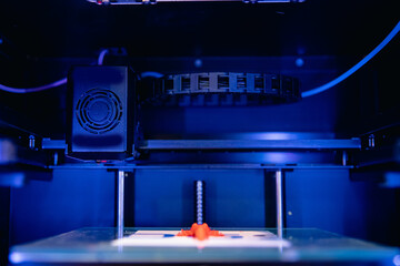 Blue color Modern 3D plastic printer printing figure close-up macro