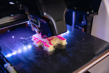 Macro photo Robot Modern 3D plastic printer printing figure