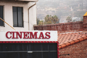 Aged and worn cinemas sign on building