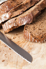 black rye bread divided into parts, fresh and soft