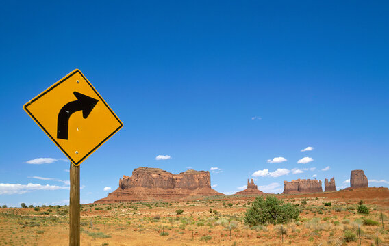 Arizona, Monument Valley Tribal Park, Road Sign In Monument Valley With West And East Mitten Buttes In Background