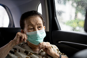 Very old Asian woman age between 80 -90 years old travel by the personal car.