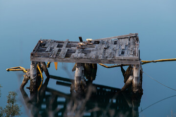 A broken wooden platform on the water.
