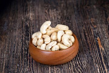 pile of cashew nuts on the table and in a wooden plate while eating