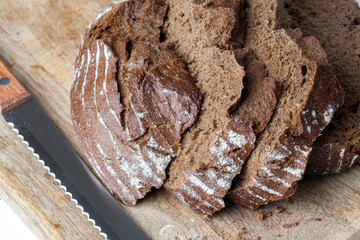 black rye bread divided into parts, fresh and soft