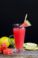a table with food and red ripe watermelons