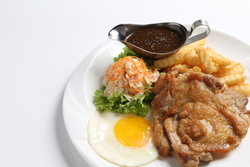 grilled golden bbq meat chicken cop pork cutlet beef steak with fried egg, French fries, coleslaw salad and black pepper sauce in pot western cuisine menu
