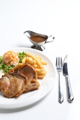 grilled golden bbq meat chicken cop pork cutlet beef steak with fried egg, French fries, coleslaw salad and black pepper sauce in pot western cuisine menu