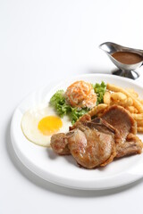 grilled golden bbq meat chicken cop pork cutlet beef steak with fried egg, French fries, coleslaw salad and black pepper sauce in pot western cuisine menu