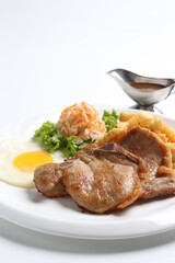 grilled golden bbq meat chicken cop pork cutlet beef steak with fried egg, French fries, coleslaw salad and black pepper sauce in pot western cuisine menu