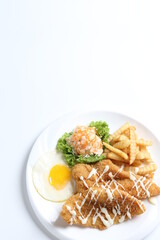 deep fried golden crispy fish fillet and chips with fried egg, French fries, coleslaw salad in tartar sauce western cuisine menu