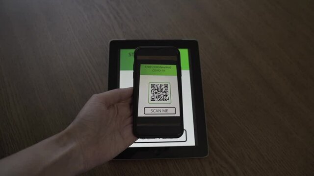 Woman in a cafe registers for a visit using a QR code. STOP Covid-19 Coronavirus