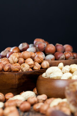 dry cashew nuts, hazelnuts and other dried fruits on an old wooden table