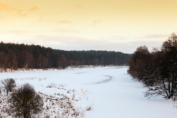 snow-covered river at sunset