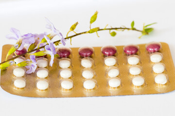 birth control pills of woman not want baby with flower arrangement flat lay style on background white 