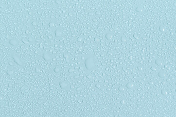 Large and small water drops on the blue background of the mine space. The texture of water drops is a close - up view from above.