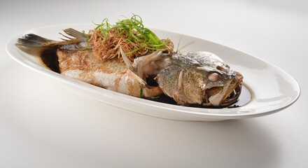 hong kong style steamed whole fresh grouper fish in soya salted sauce and ginger and garlic onion seafood asian menu