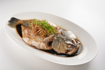 hong kong style steamed whole fresh grouper fish in soya salted sauce and ginger and garlic onion seafood asian menu